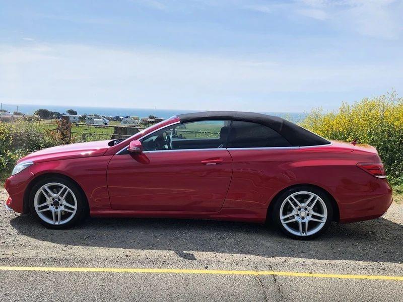 A red Mercedes viewed from the passenger side