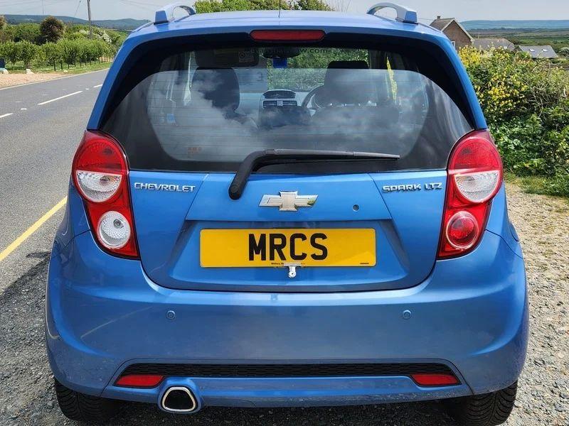 A blue Chevrolet viewed from the back