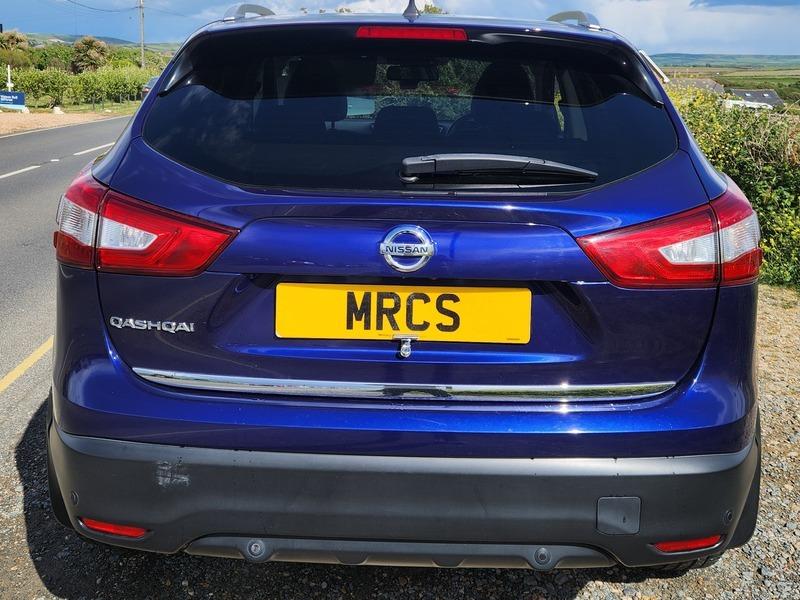 A blue Nissan Qashqai SUV viewed from the back