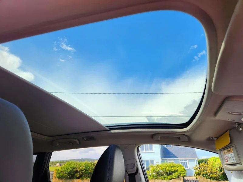 The rooflight of a blue Nissan Qashqai SUV from inside the car