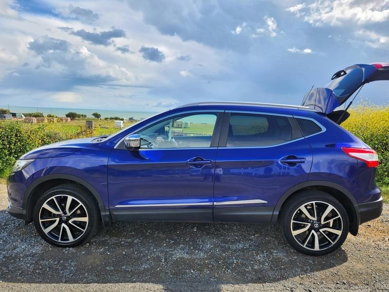 A blue Nissan Qashqai SUV viewed from the passenger side