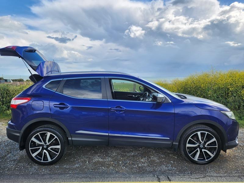 A blue Nissan Qashqai SUV viewed from the driver side