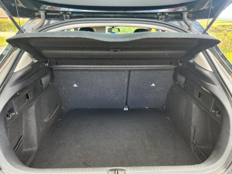 The open boot of a black Citroen C4 viewed from the back