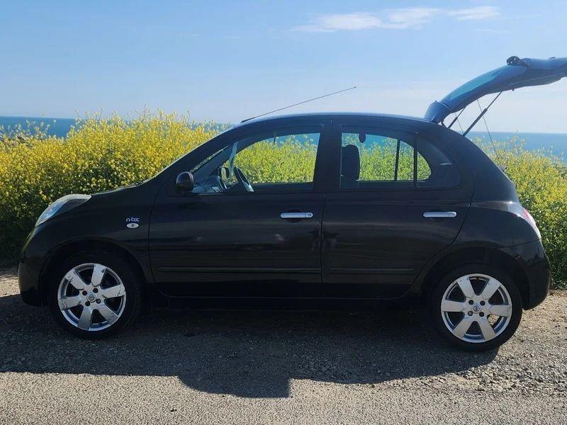 A black Nissan Micra viewed from the passenger side