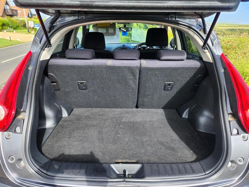 The open boot of a grey Nissan Juke viewed from the back