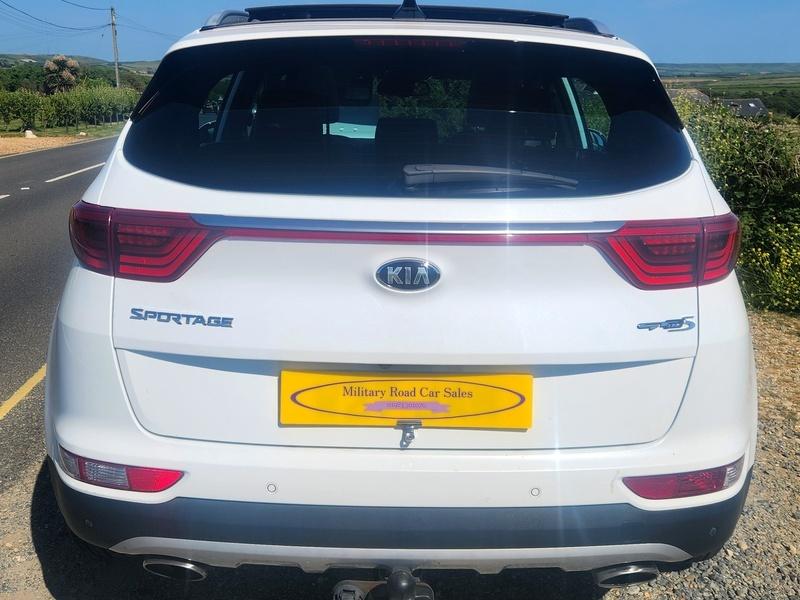 A white KIA Sportage viewed from the back