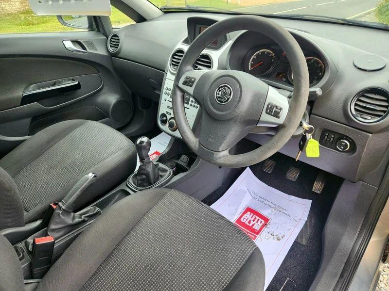 The steering controls of a brown Vauxhall Corsa viewed from above the driver seat