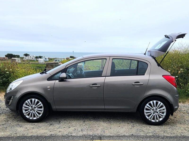 A brown Vauxhall Corsa viewed from the passenger side