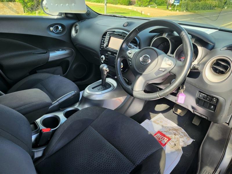 The steering controls of a grey Nissan Juke viewed from above the driver seat