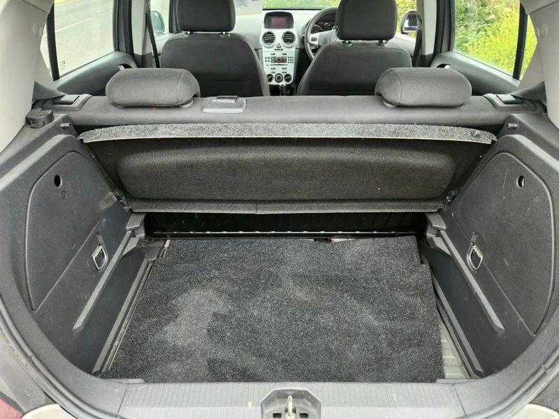 The open boot of a brown Vauxhall Corsa viewed from the back