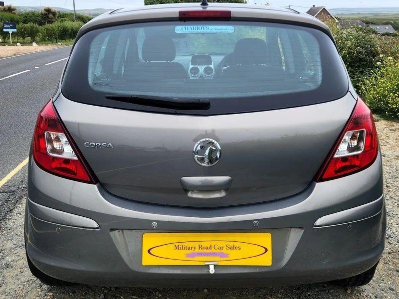 A brown Vauxhall Corsa viewed from the back