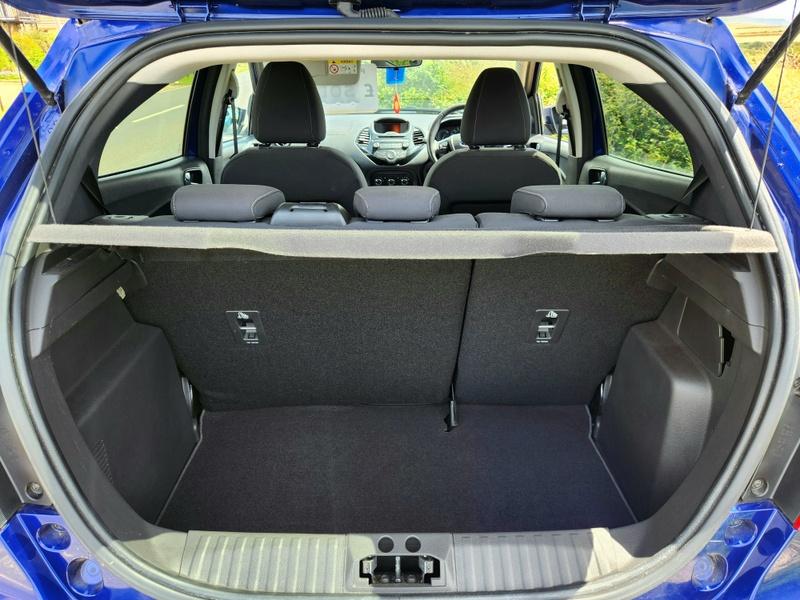 The open boot of a blue Ford Ka viewed from the back