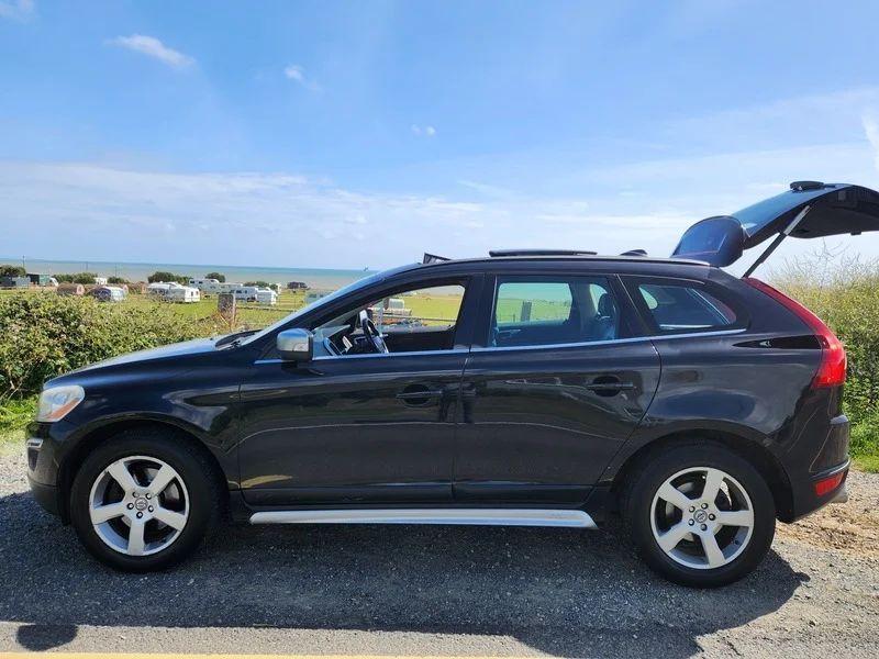 A black Volvo XC60 viewed from the passenger side