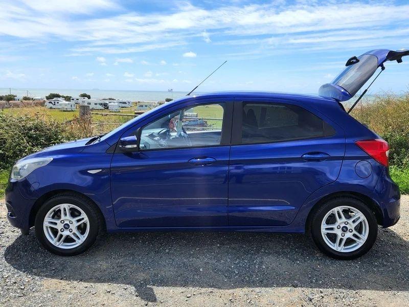 A blue Ford Ka viewed from the passenger side