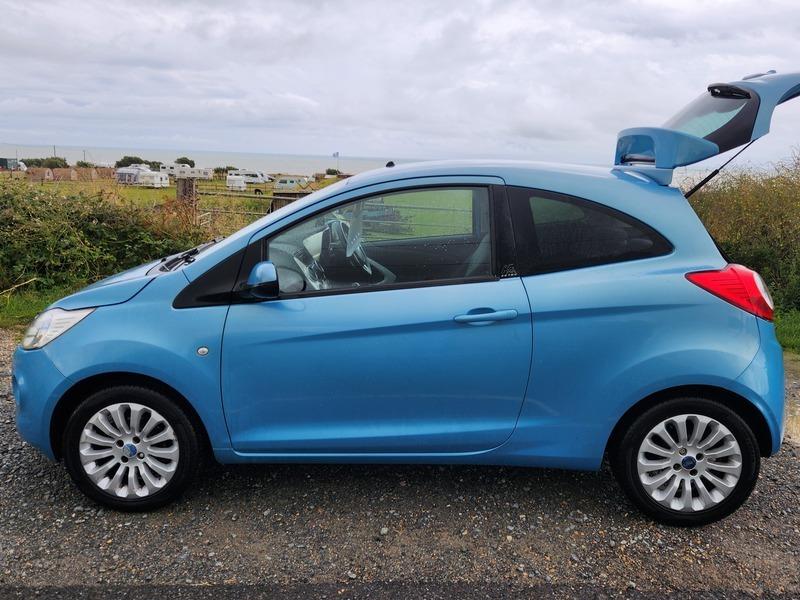 A blue Ford Ka viewed from the passenger side