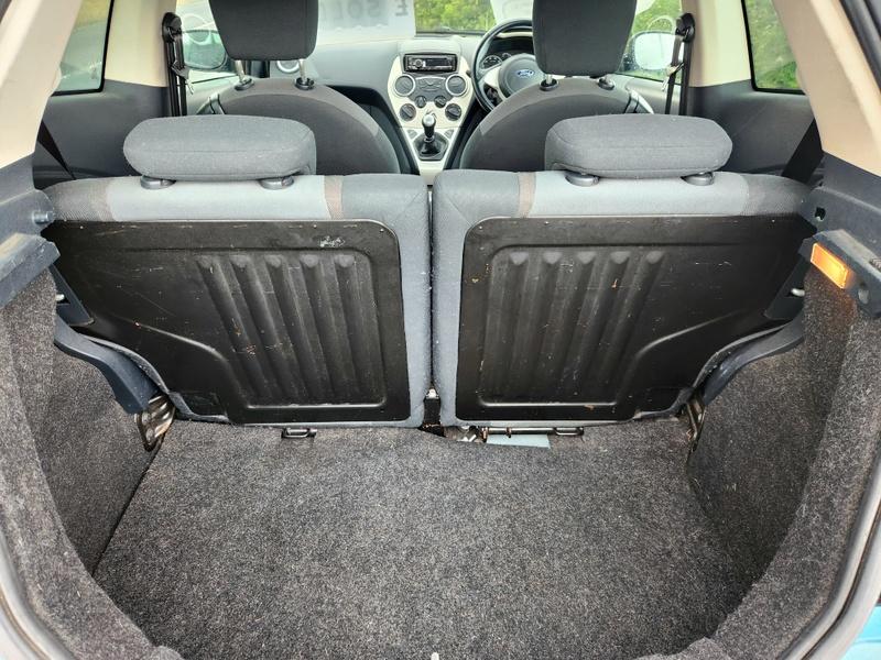 The open boot of a blue Ford Ka viewed from the back