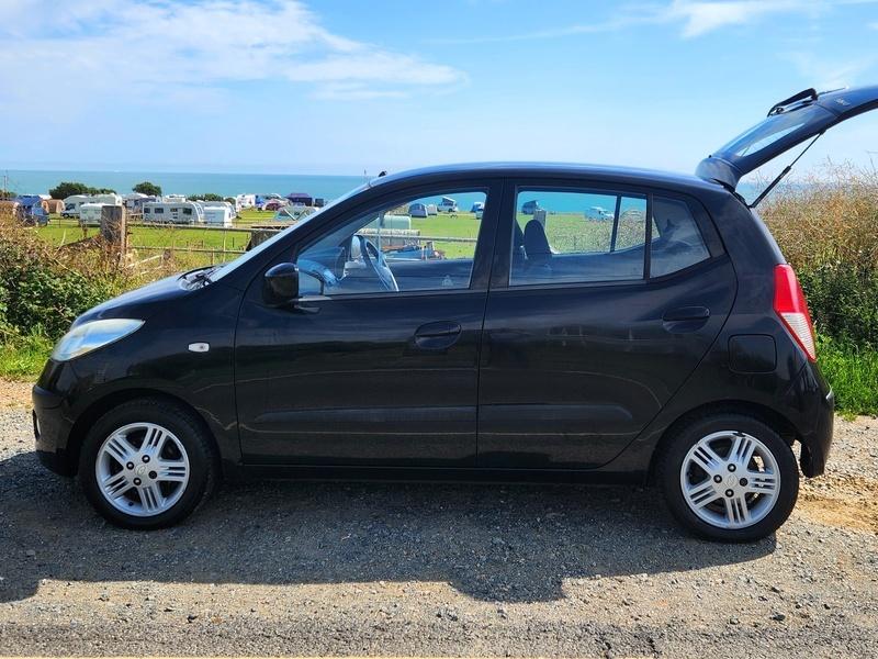 A black Hyundai i10 viewed from the passenger side