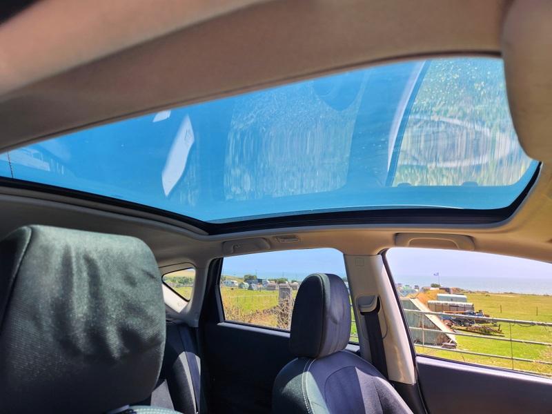 The sunroof of a silver Nissan Qashqai viewed from the driver seat