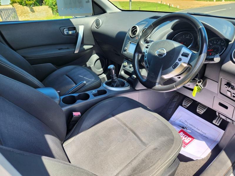 The steering controls of a silver Nissan Qashqai viewed from above the driver seat
