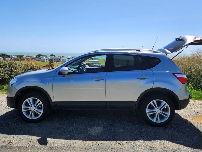 A silver Nissan Qashqai viewed from the passenger side