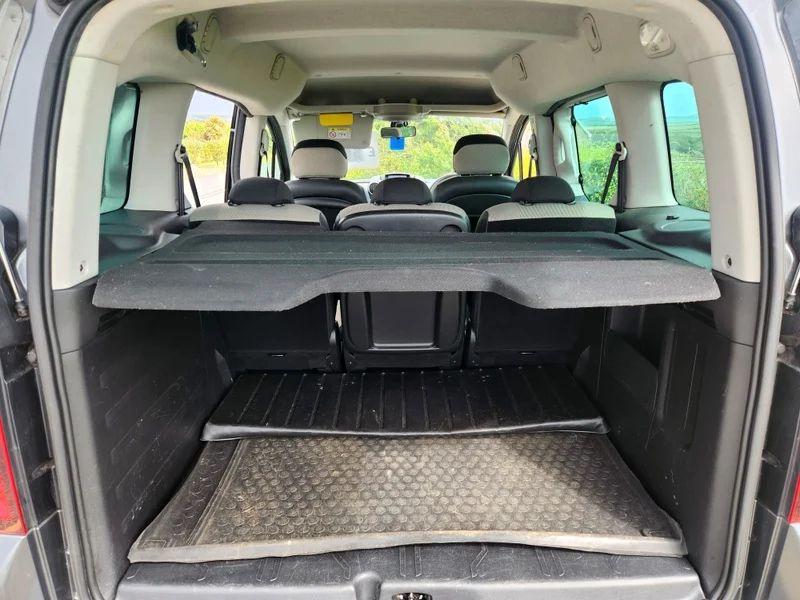 The open boot of a black Citroen Berlingo viewed from the back