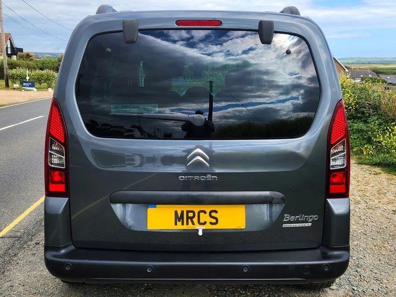 A black Citroen Berlingo viewed from the back
