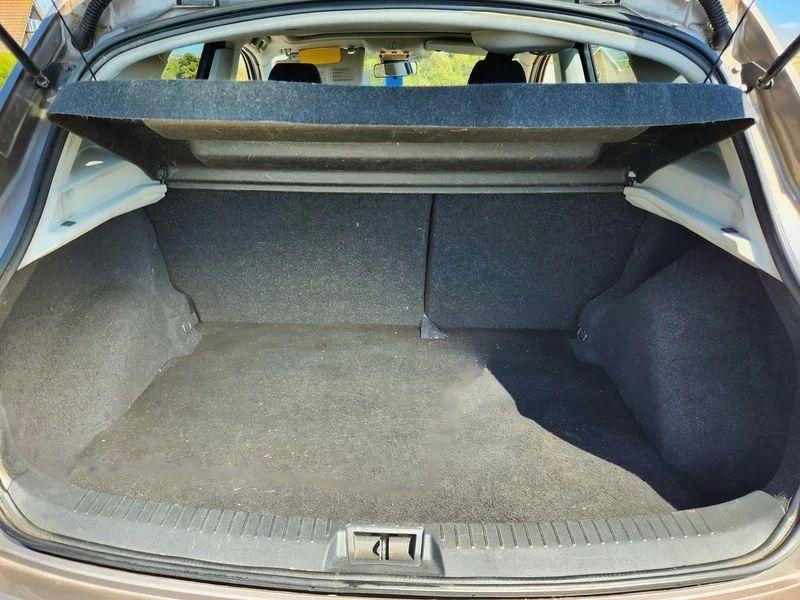 The open boot of a gold Nissan Qashqai viewed from the back