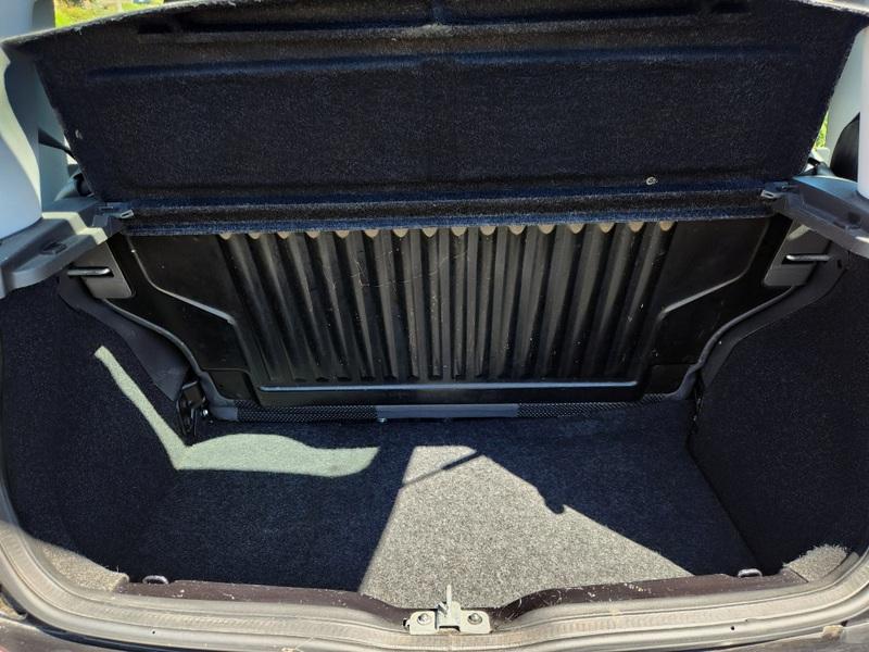 The open boot of a black Fiat Panda viewed from the back