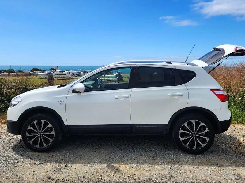 A white Nissan Qashqai viewed from the passenger side