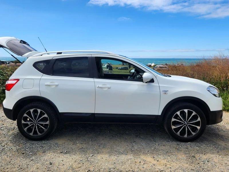 A white Nissan Qashqai viewed from the driver side