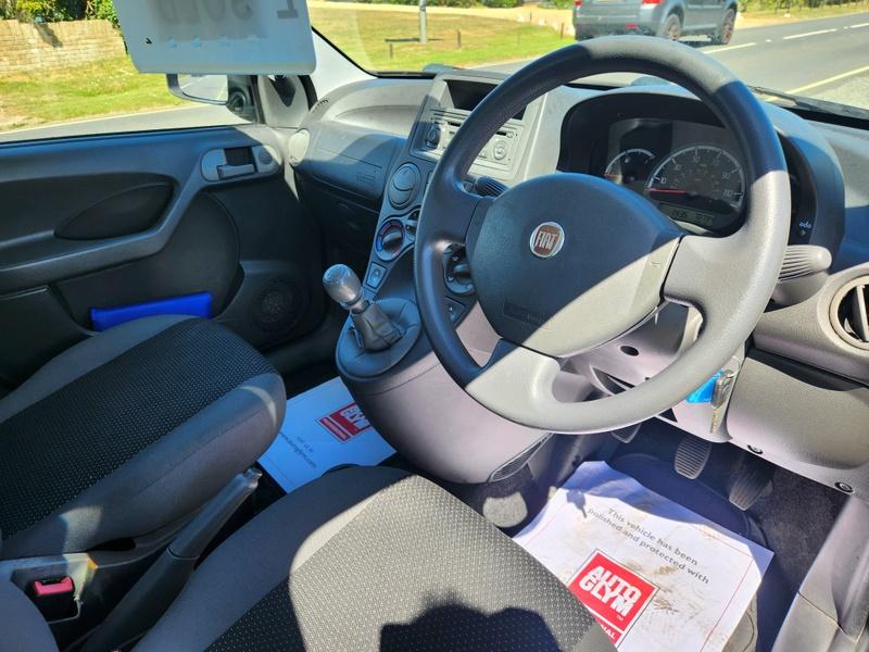 The steering controls of a black Fiat Panda viewed from above the driver seat