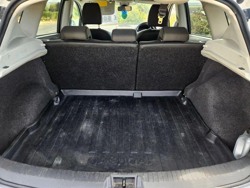 The open boot of a white Nissan Qashqai viewed from the back