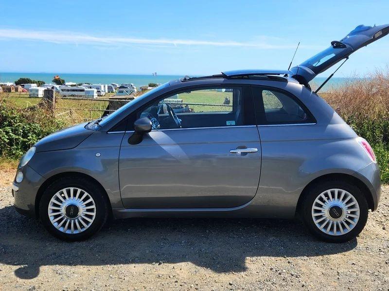 A grey Fiat 500 Lounge viewed from the passenger side
