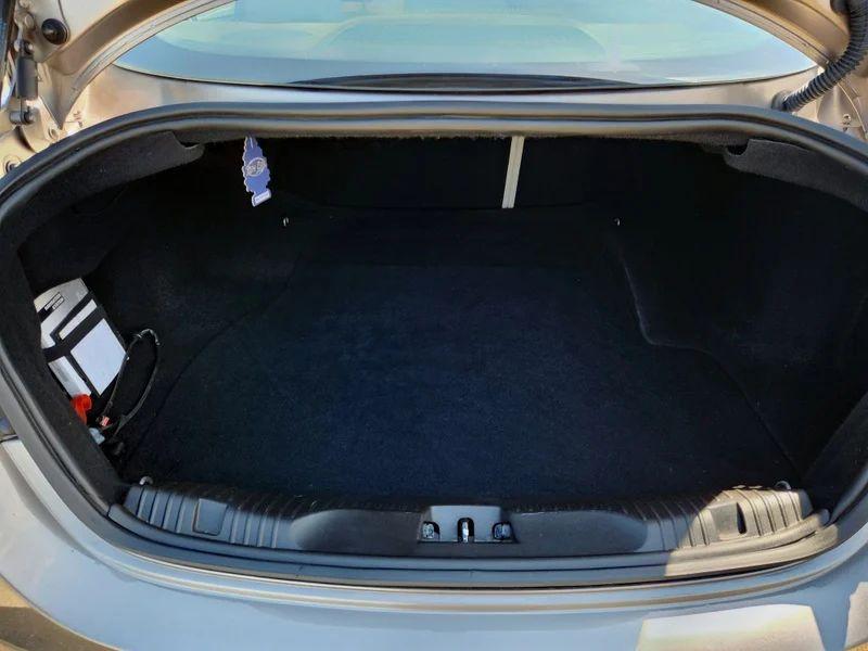 The open boot of a grey Jaguar XF viewed from the back