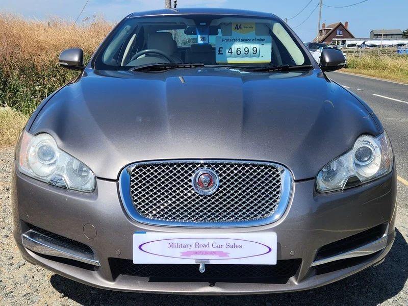 A grey Jaguar XF viewed from the front