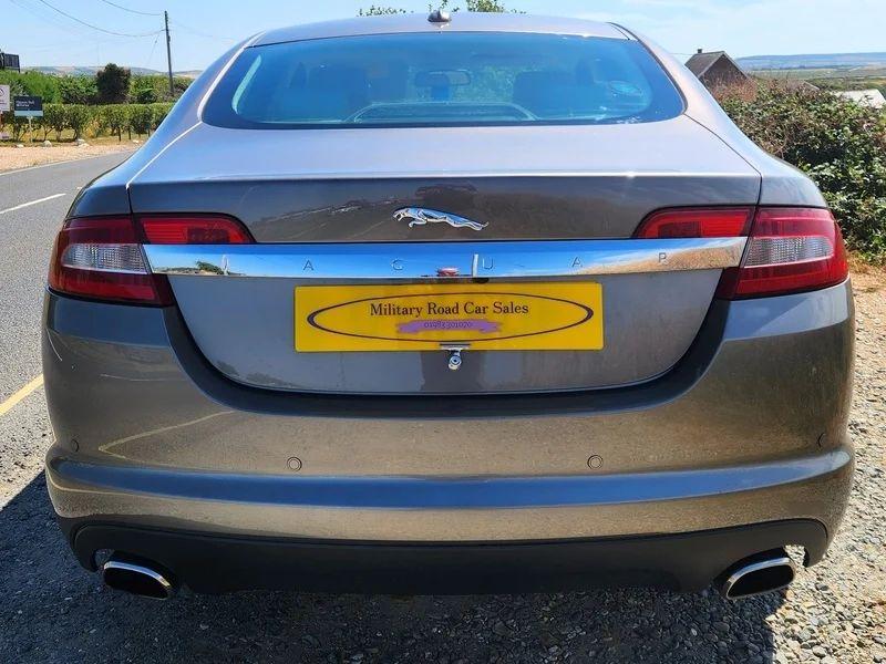 A grey Jaguar XF viewed from the back