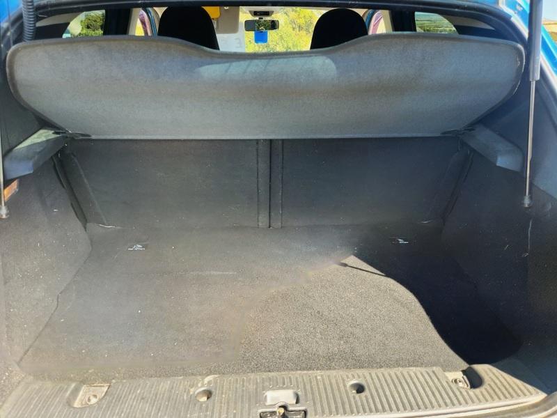 The open boot of a blue Renault Twingo viewed from the back
