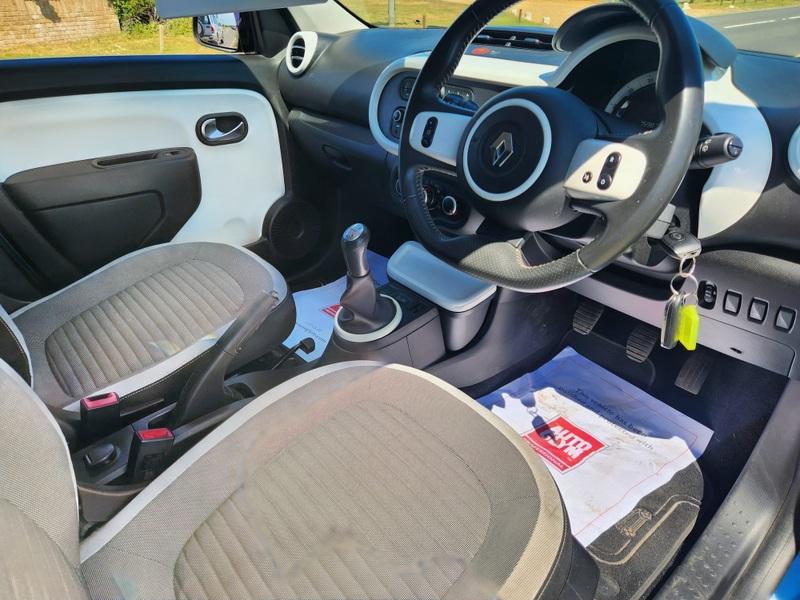 The steering controls of a blue Renault Twingo viewed from above the driver seat