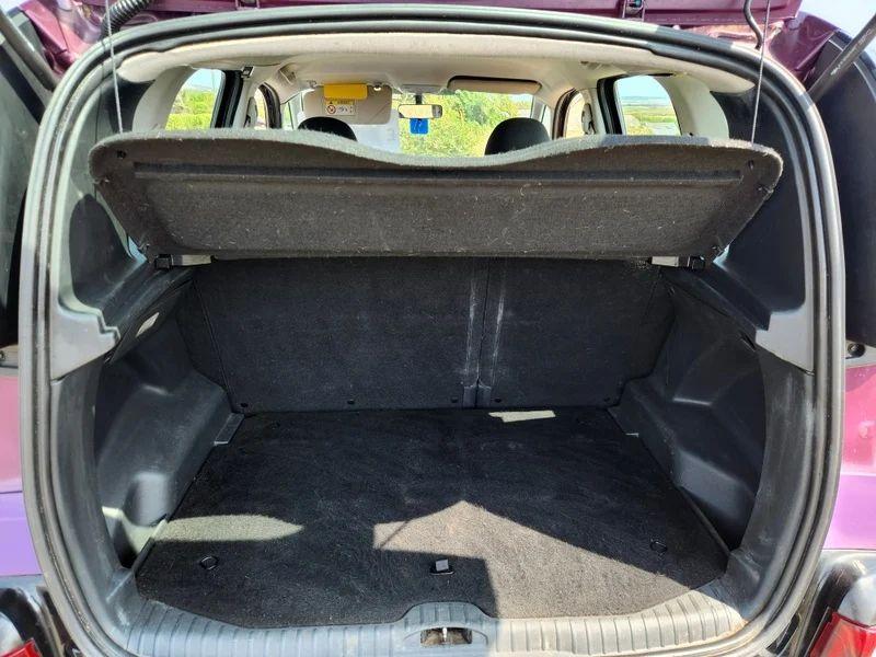 The open boot of a violet Citroen C3 Picasso viewed from the back