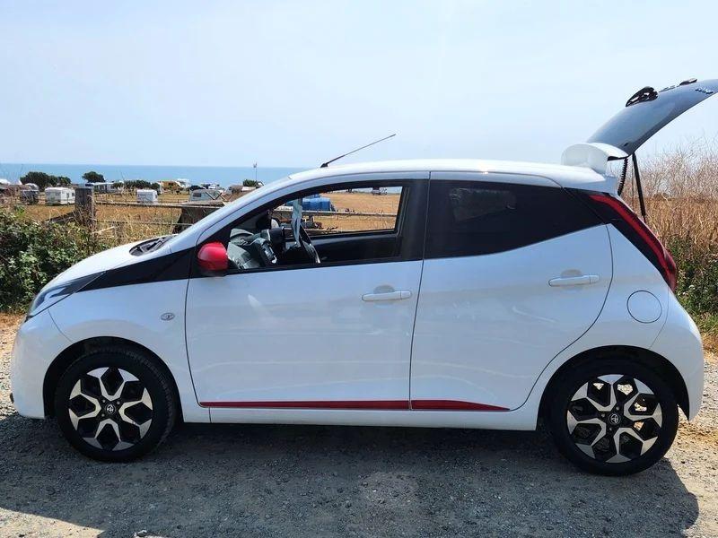 A white Toyota Aygo viewed from the passenger side