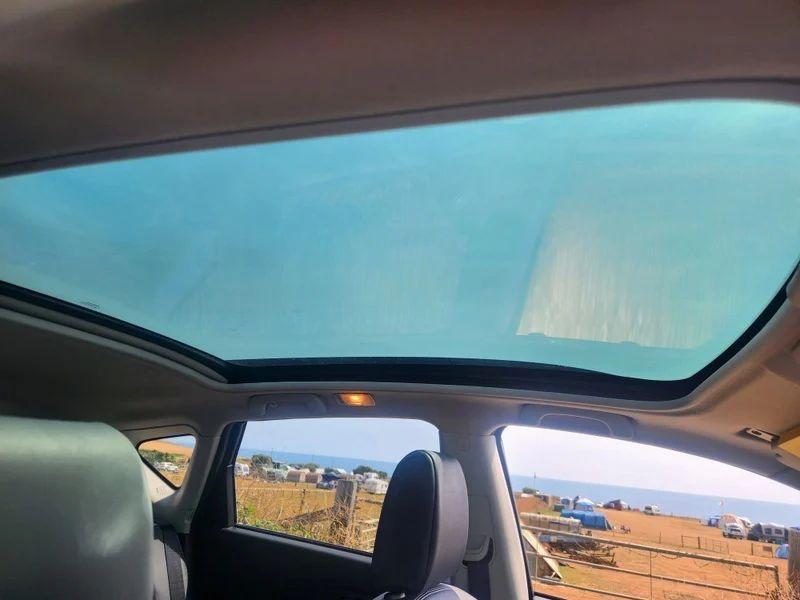 The sunroof of a grey Nissan Qashqai viewed from the driver seat