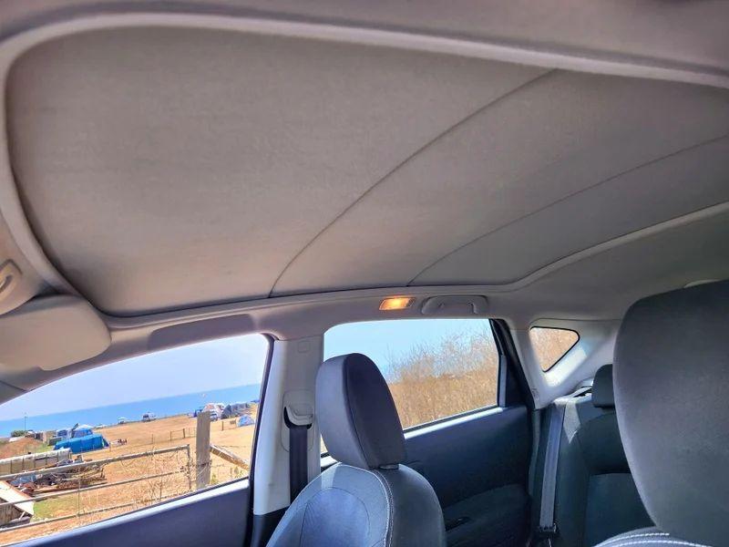 The sunroof cover of a black Nissan Qashqai viewed from the passenger seat