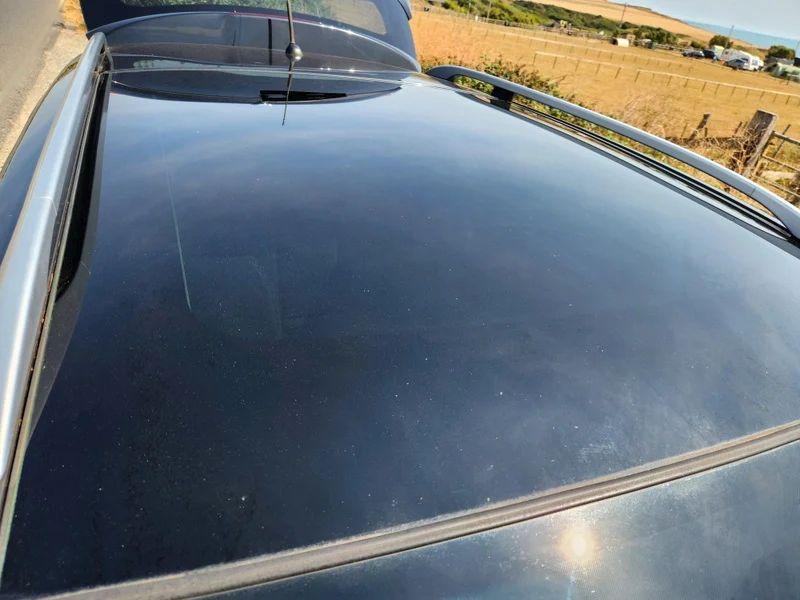 The sunroof of a black Nissan Qashqai viewed from above