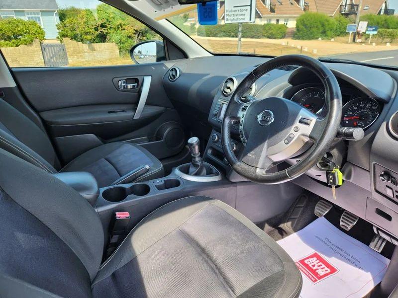 The steering controls of a black Nissan Qashqai viewed from above the driver seat