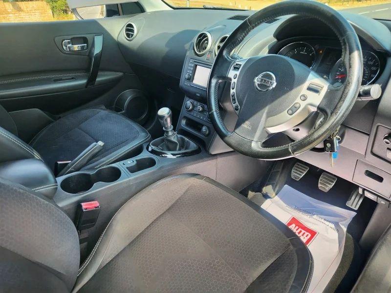 The steering controls of a grey Nissan Qashqai viewed from above the driver seat