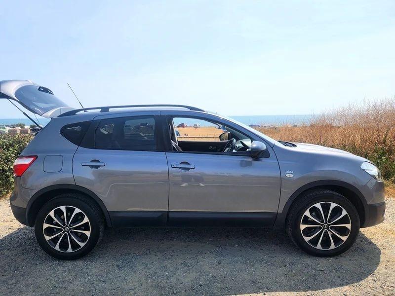 A grey Nissan Qashqai viewed from the driver side