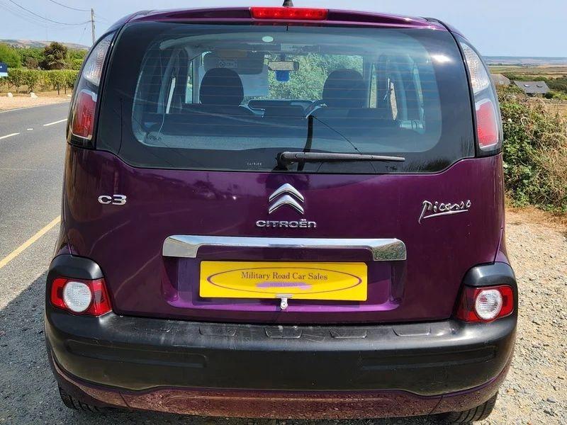 A violet Citroen C3 Picasso viewed from the back