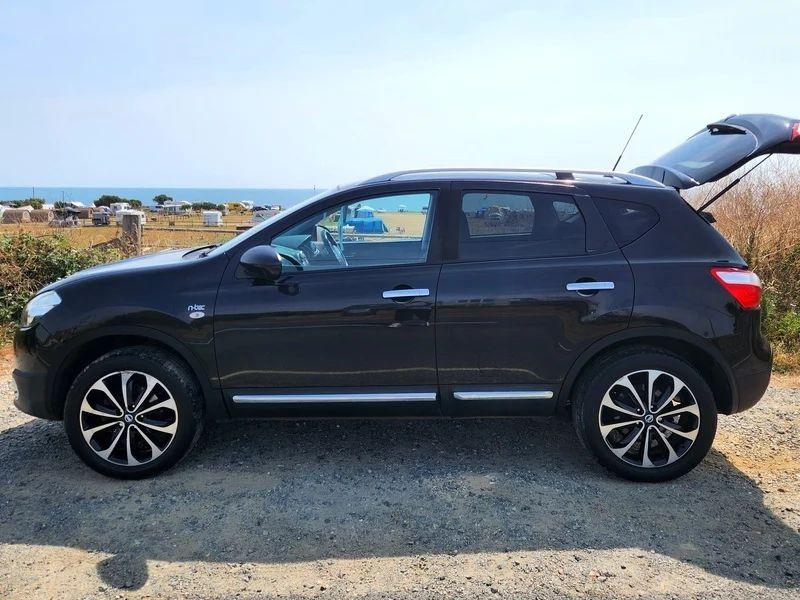 A black Nissan Qashqai viewed from the passenger side