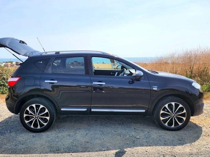 A black Nissan Qashqai viewed from the driver side