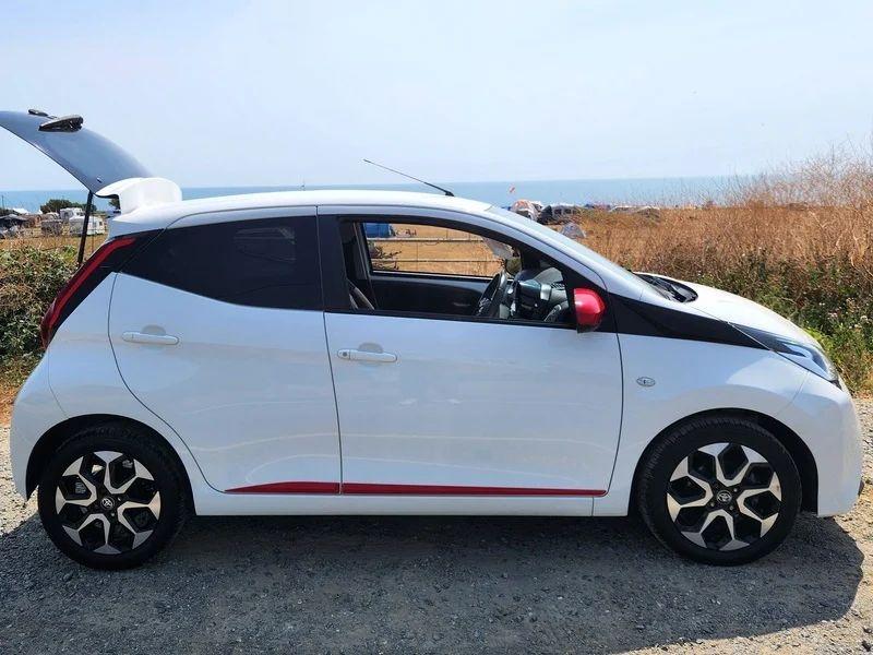 A white Toyota Aygo viewed from the driver side